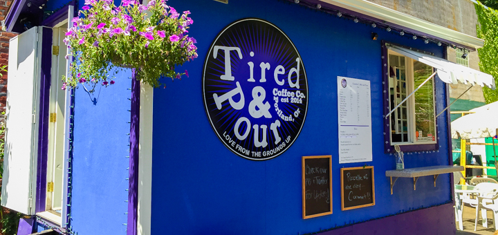 Tired & Pour logo imprinted on the side of their bright blue food cartaTired & Pour logo imprinted on the side of their bright blue food cart