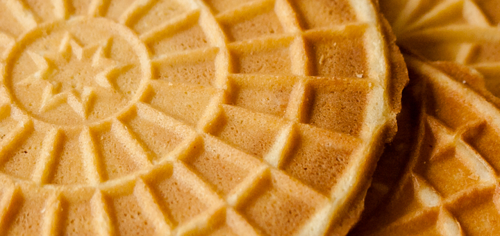 A close up image of pizzelles showing the texture made by the pizzelle iron