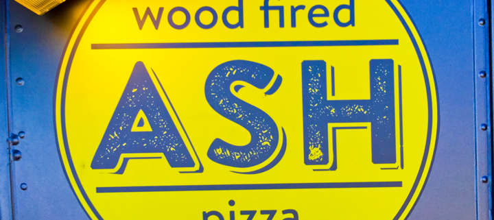 The ASH Wood Fired logo as seen on the side of the food cart
