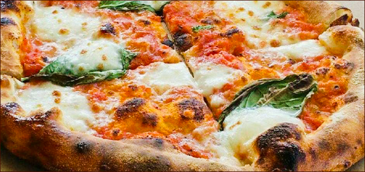 The ASH Wood Fired pizza made with the wood-burning oven that is located inside the food cart