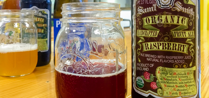 A bottle of Samuel Smith Rasberry Ale and a mason jar with Samuel Smith's Rasberry Ale in the jar.