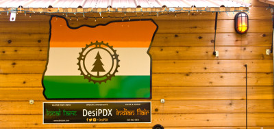 Desi PDX food cart in its pod with the Desi PDX sign