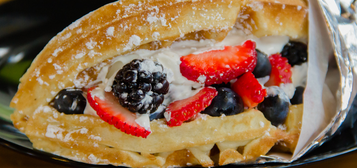 A photo of the waffle handwich filled with fresh berries and whipped cream from Rose City Waffles food cart located at the Happy Valley Station food cart pod.